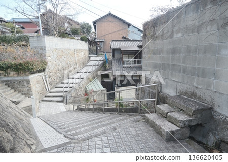 A residential area in Japan with slopes and stone steps 136620405
