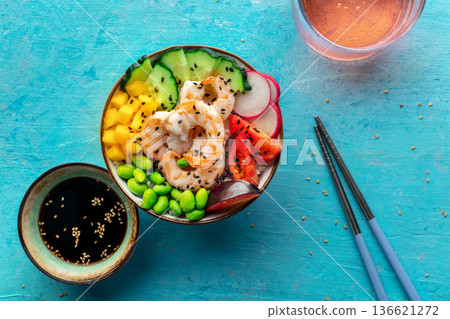 Poke bowl with shrimps, tomatoes, cucumber, mango, edamame, overhead shot 136621272