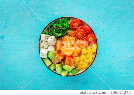 Salmon poke bowl with mango, avocado, tofu, wakame, cherry tomatoes Salmon poke bowl with mango, avocado, tofu, wakame, cherry tomatoes 136621273
