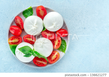 Buffalo Mozzarella, fresh cherry tomatoes, and basil leaves, Caprese salad Buffalo Mozzarella, fresh cherry tomatoes, and basil leaves, Caprese salad 136621277