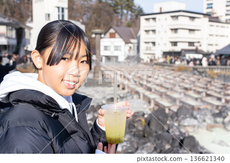 A teenage girl visiting the Yubatake hot springs on a trip to Kusatsu Onsen A teenage girl visiting the Yubatake hot springs on a trip to Kusatsu Onsen 136621340
