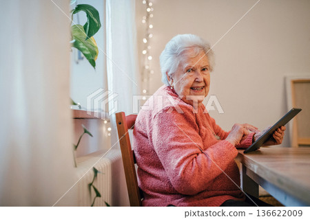 Older woman using tablet, shopping online. 136622009
