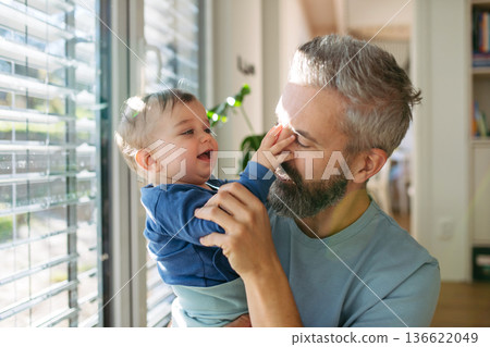 Little boy holding his fathers nose. Little boy holding his fathers nose. 136622049