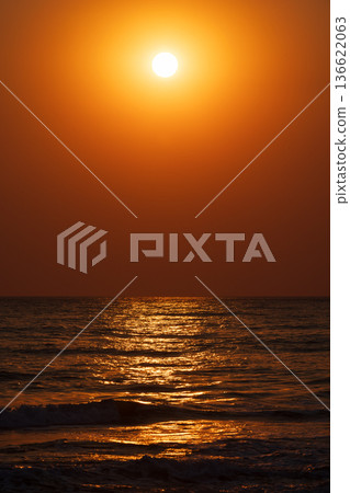 An atmospheric vertical image capturing sunser sun An atmospheric vertical image capturing sunser sun 136622063