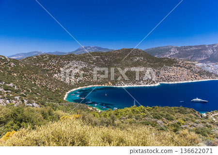A stunning deep blue bay sheltered by rugged hills A stunning deep blue bay sheltered by rugged hills 136622071