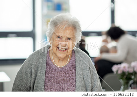 Smiling elderly woman looking at camera. Smiling elderly woman looking at camera. 136622118