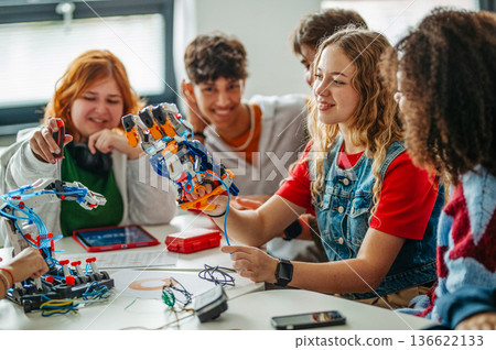 Diverse group of students working on engineering school project. Diverse group of students working on engineering school project. 136622133