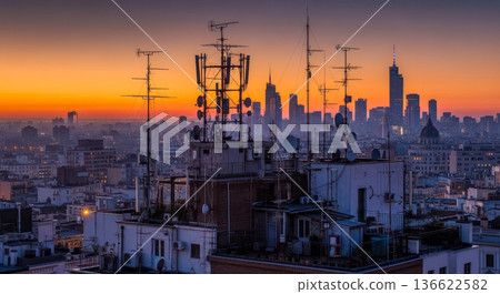 skyline at sunset with telecommunication antennas on rooftop technology concept for 5g network data and global communication urban european cityscape 136622582