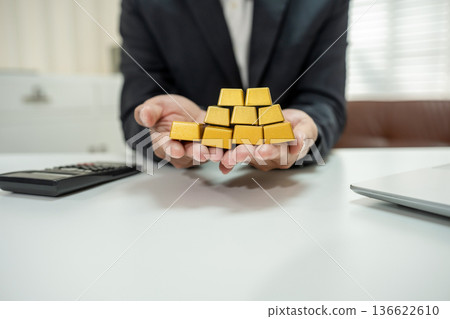 Businesman trading stocks online. Stock brokers looking at graphs, indexes and numbers on tablet and calculating. Businesman trading stocks online. Stock brokers looking at graphs, indexes and numbers on tablet and calculating. 136622610