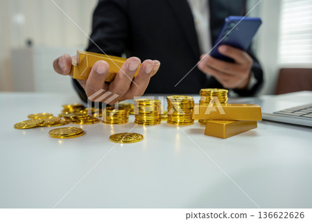 Businesman trading stocks online. Stock brokers looking at graphs, indexes and numbers on tablet and calculating. Businesman trading stocks online. Stock brokers looking at graphs, indexes and numbers on tablet and calculating. 136622626
