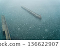 Snowstorm sea, breakwater, poor visibility, cold winter port, silent water surface Snowstorm sea, breakwater, poor visibility, cold winter port, silent water surface 136622907