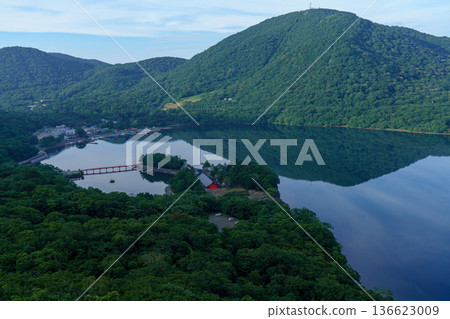 Lake Onuma and the mountain range seen from the Mount Akagi hiking trail. A tranquil lakescape in Gunma Prefecture. Lake Onuma and the mountain range seen from the Mount Akagi hiking trail. A tranquil lakescape in Gunma Prefecture. 136623009