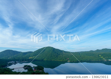 Lake Onuma and the mountain range seen from the Mount Akagi hiking trail. A tranquil lakescape in Gunma Prefecture. 136623011