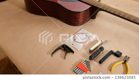 Guitar Maintenance: Adjusting and Changing Strings With Tools on Work Surface Guitar Maintenance: Adjusting and Changing Strings With Tools on Work Surface 136623085