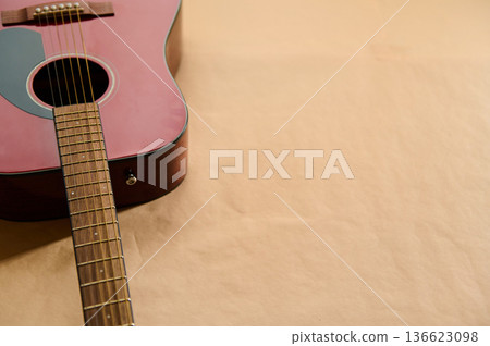Acoustic Guitar On Paper Surface - Guitar Strings Maintenance And Repair Concept 136623098