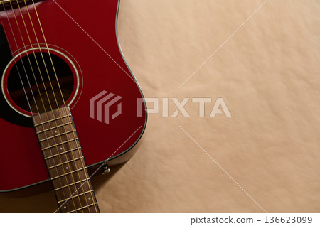 Red Acoustic Guitar With Focus on String Maintenance and Repair, Changing and Adjusting Strings Red Acoustic Guitar With Focus on String Maintenance and Repair, Changing and Adjusting Strings 136623099