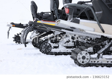 Snow-covered snowmobile tracks. High quality photo Snow-covered snowmobile tracks. High quality photo 136623152