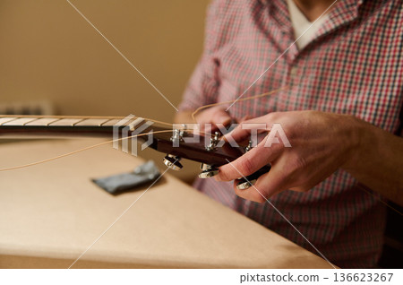 Master Adjusting and Changing Guitar Strings - Guitar Maintenance and Repair Close-Up Master Adjusting and Changing Guitar Strings - Guitar Maintenance and Repair Close-Up 136623267