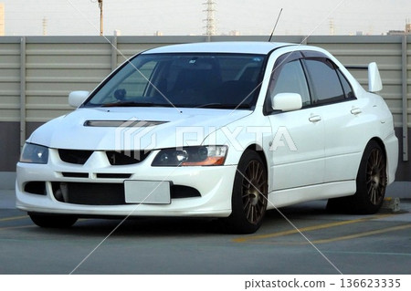 White car parked in a parking lot White car parked in a parking lot 136623335
