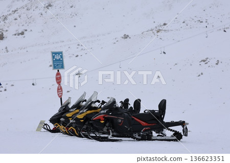 Snowmobiles winter landscape Snowy snowmobile solitude. High quality photo Snowmobiles winter landscape Snowy snowmobile solitude. High quality photo 136623351