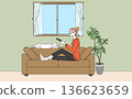 A cat and a woman relaxing in a room 136623659