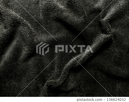 luxurious black velvet fabric texture with soft elegant folds in closeup for premium dark wallpaper or banner copy space 136624032
