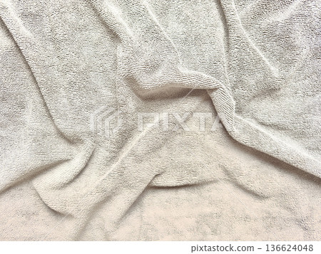 soft beige terry towel elegantly folded on pastel blue background with ample copy space for spa banner or wellness wallpaper soft beige terry towel elegantly folded on pastel blue background with ample copy space for spa banner or wellness wallpaper 136624048