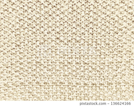 creamy beige knitted wool texture macro closeup evoking cozy warmth and subtle elegance for neutral wallpaper background or textile design banner 136624166