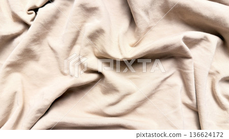 flowing beige jersey fabric draped in gentle waves evoking serene minimalist texture for neutral wallpaper or design banner flowing beige jersey fabric draped in gentle waves evoking serene minimalist texture for neutral wallpaper or design banner 136624172