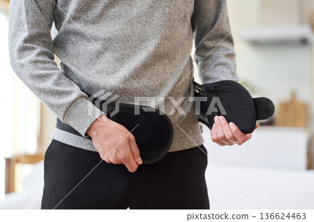 Asian man wearing a corset around his waist 136624463