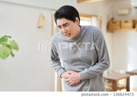 Asian man suffering from pain in his side Asian man suffering from pain in his side 136624473