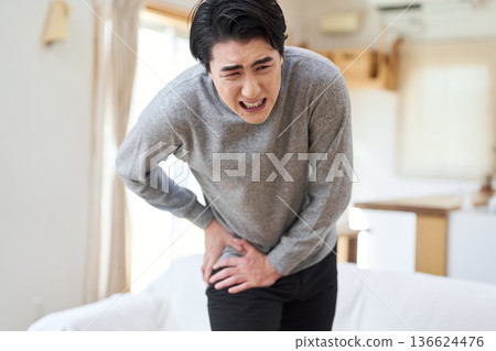 Asian man suffering from hip pain 136624476