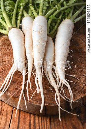 Bunch of fresh daikon radish with roots and leaves Bunch of fresh daikon radish with roots and leaves 136624551