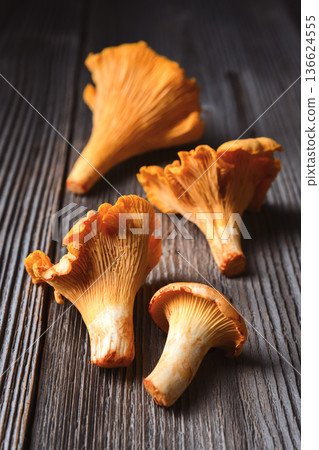 Chanterelle mushrooms on old wooden table Chanterelle mushrooms on old wooden table 136624555