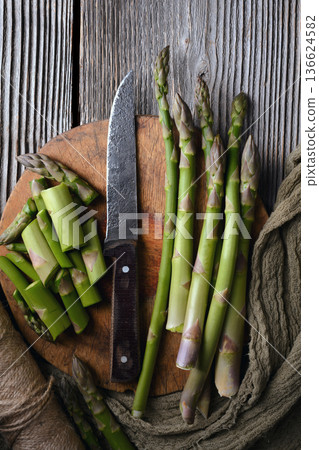 Fresh green asparagus arranged with fabric napkin 136624582