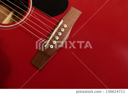 Red Acoustic Guitar Bridge and Strings Close-Up - Guitar Maintenance and Repair Red Acoustic Guitar Bridge and Strings Close-Up - Guitar Maintenance and Repair 136624711