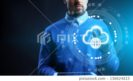 Person using a tablet to access cloud services in a dark room 136624815