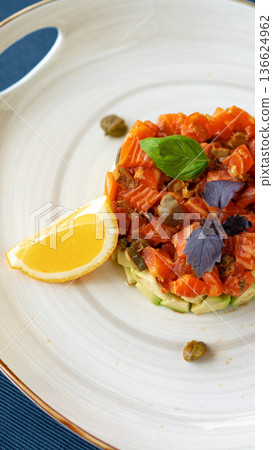 Fresh fish dish with lemon and herbs served on a round plate in a restaurant setting Fresh fish dish with lemon and herbs served on a round plate in a restaurant setting 136624962