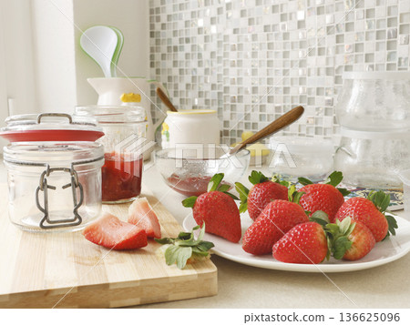 Composition of fresh strawberries and empty jars in kitchen. Seasonal farm produce and homemade preserves. Design backdrop. Composition of fresh strawberries and empty jars in kitchen. Seasonal farm produce and homemade preserves. Design backdrop. 136625096