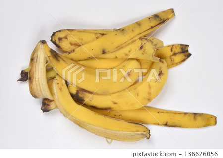 Pile of yellow banana peels on white background Pile of yellow banana peels on white background 136626056