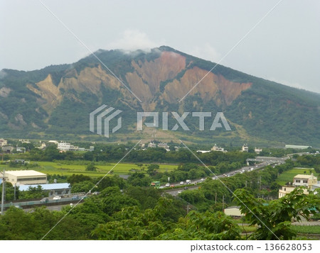Taichung, Taiwan - 06.10.2016: A distant view from the Taian Rest Stop in Houli, Taichung, of Yuanli, Miaoli, and Huoyanshan, the border of Sanyi. Taichung, Taiwan - 06.10.2016: A distant view from the Taian Rest Stop in Houli, Taichung, of Yuanli, Miaoli, and Huoyanshan, the border of Sanyi. 136628053
