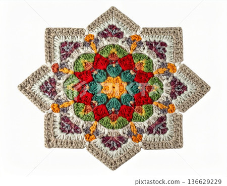 Detailed Crochet Star Motif in Red Green and Beige Against a White Background 136629229