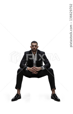 A graceful leader in deep charcoal, seated calmly on a floating ring, symbolizing unity, visionary control, and circular thinking 136629702