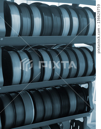 Spool of plastic wire for 3D printing. Different spool with plastic close-up. Component for 3d printing. Printing accessories. Concept 3D printing technology. Additive progressive FDM technologies 136629759