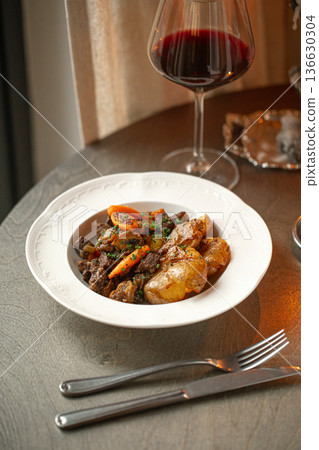 French beef bourguignon with wine and potatoes 136630304