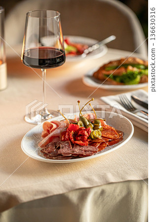 Italian antipasti platter with meat and wine Italian antipasti platter with meat and wine 136630316