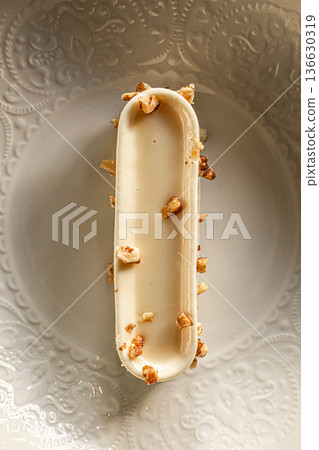 Creamy mousse dessert with nuts on plate Creamy mousse dessert with nuts on plate 136630319