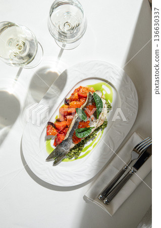 Seared fish fillet with vegetables and green sauce 136630337