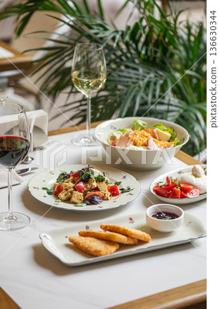 Italian restaurant table with food and wine Italian restaurant table with food and wine 136630344