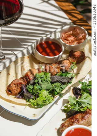 Caucasian lamb shashlik with red sauce and onions Caucasian lamb shashlik with red sauce and onions 136630348